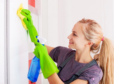 After builders cleaning removing dust from a renovated room
